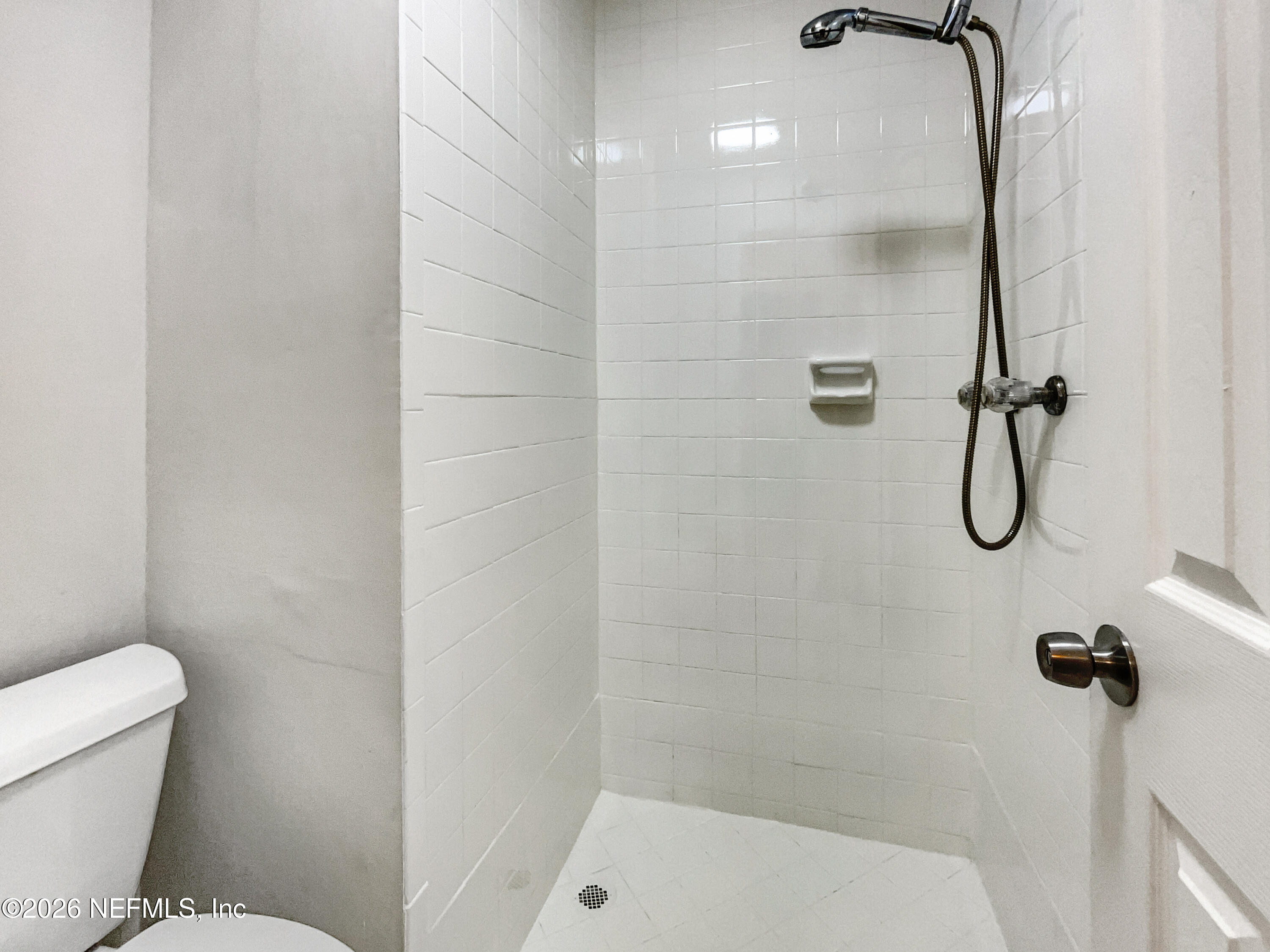 7208 Cypress Cove Road, Unit 13 Jacksonville, FL 32244 - Photo 18 of 22 a bathroom with a shower and a toilet