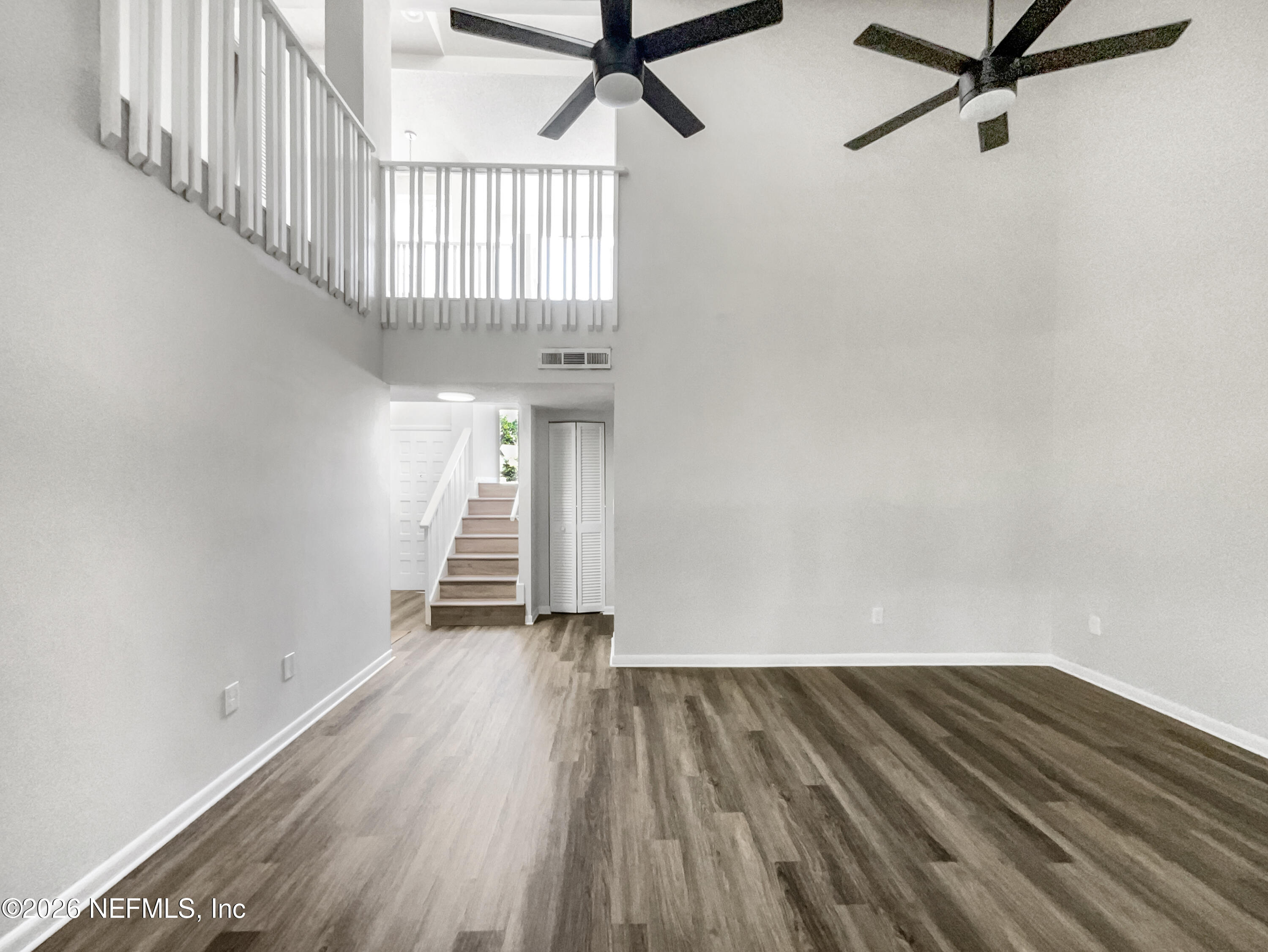 7208 Cypress Cove Road, Unit 13 Jacksonville, FL 32244 - Photo 4 of 22 a view of a room with wooden floor and white walls