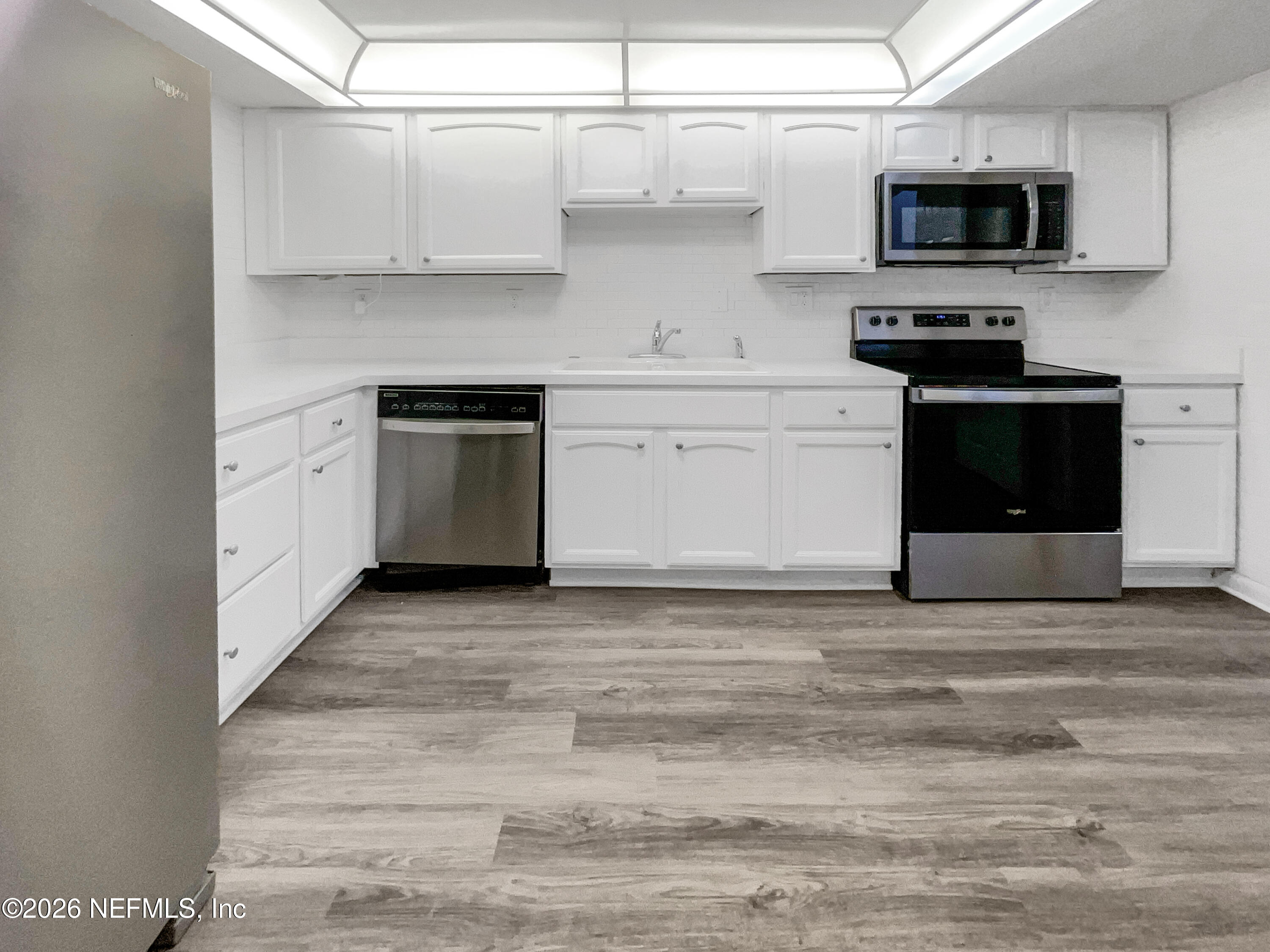 7208 Cypress Cove Road, Unit 13 Jacksonville, FL 32244 - Photo 6 of 22 a kitchen with stainless steel appliances granite countertop a stove and a sink