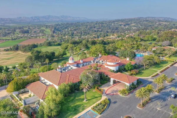 an aerial view of residential houses with outdoor space and river