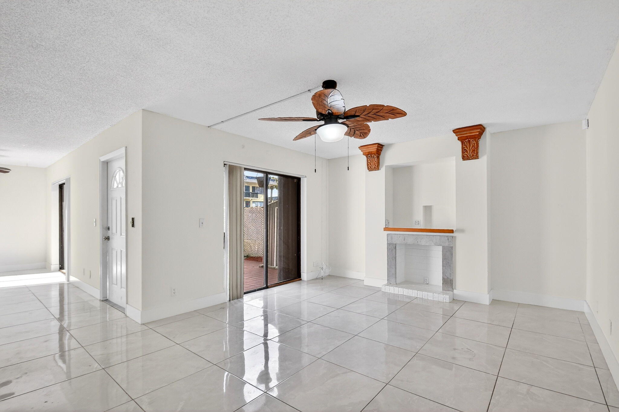 136 Woodland Road Palm Springs, FL 33461 - Photo 15 of 42 a view of a room with a chandelier fan and kitchen view