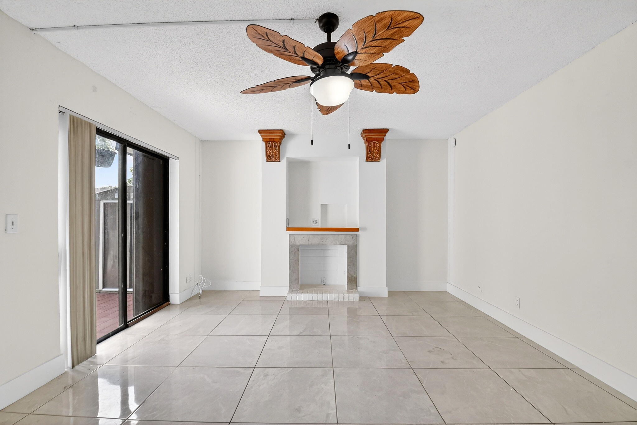 136 Woodland Road Palm Springs, FL 33461 - Photo 16 of 42 a view of an empty room with a ceiling fan