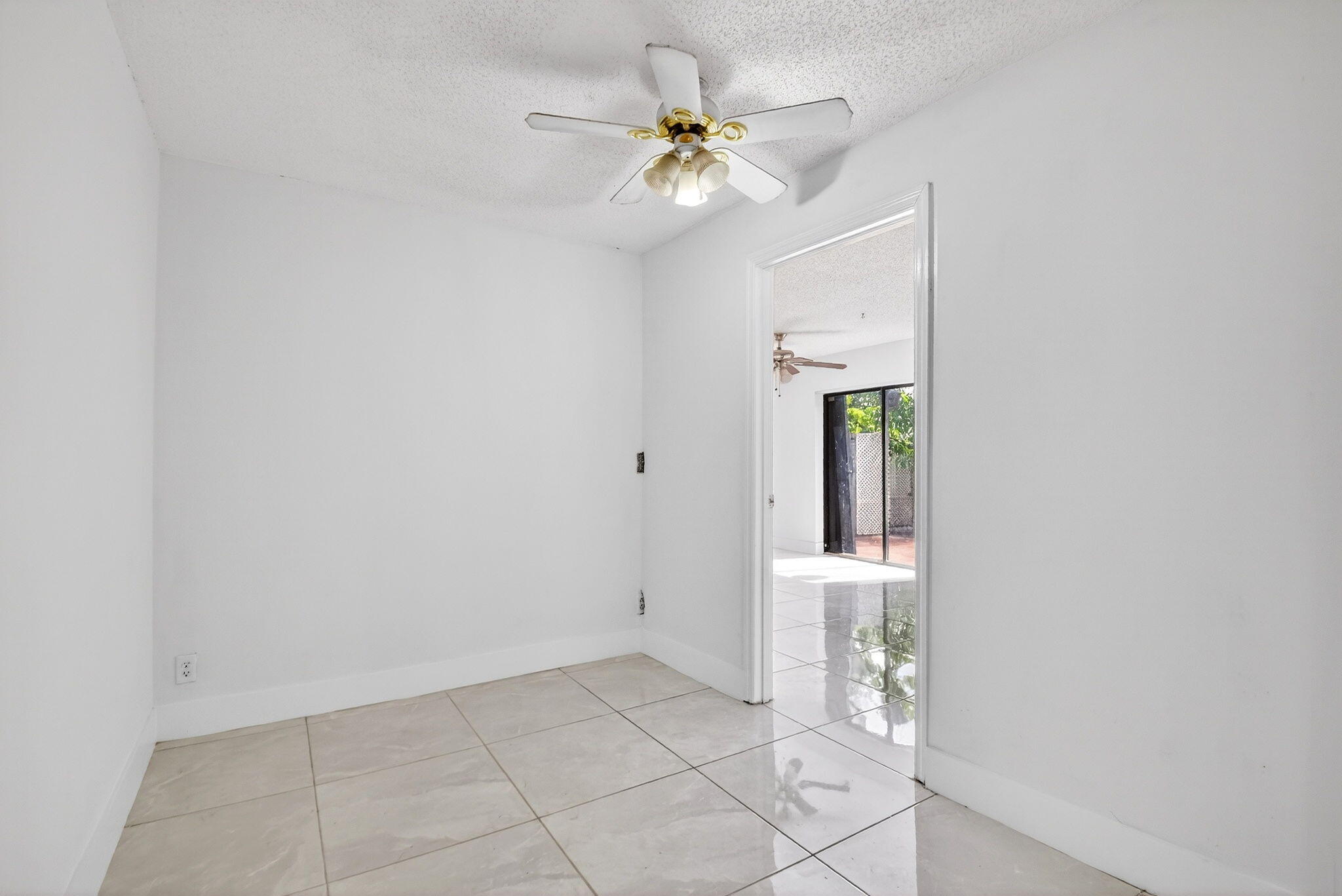 136 Woodland Road Palm Springs, FL 33461 - Photo 20 of 42 wooden floor in an empty room with a window
