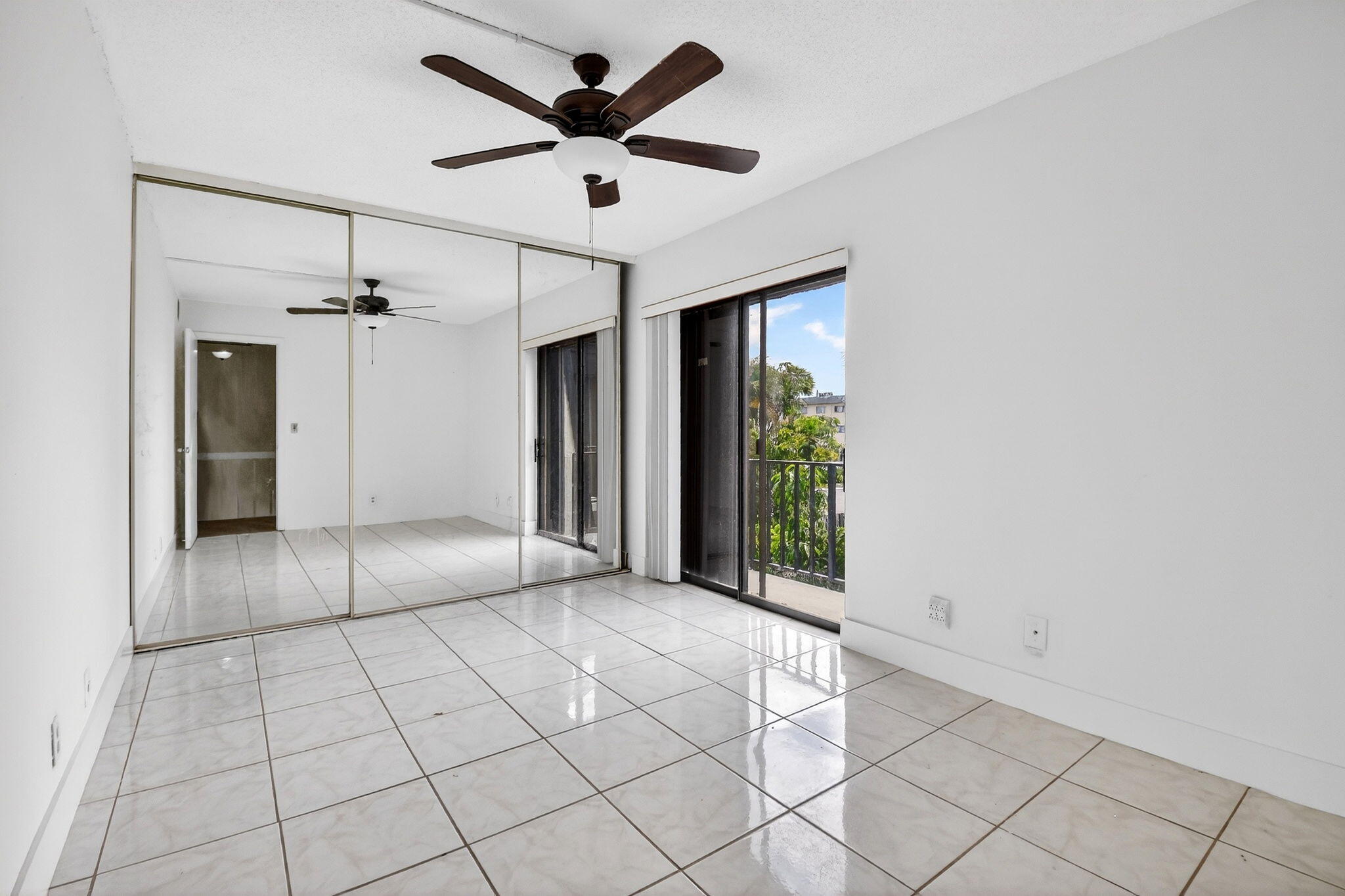 136 Woodland Road Palm Springs, FL 33461 - Photo 26 of 42 a view of a livingroom with a chandelier fan and windows