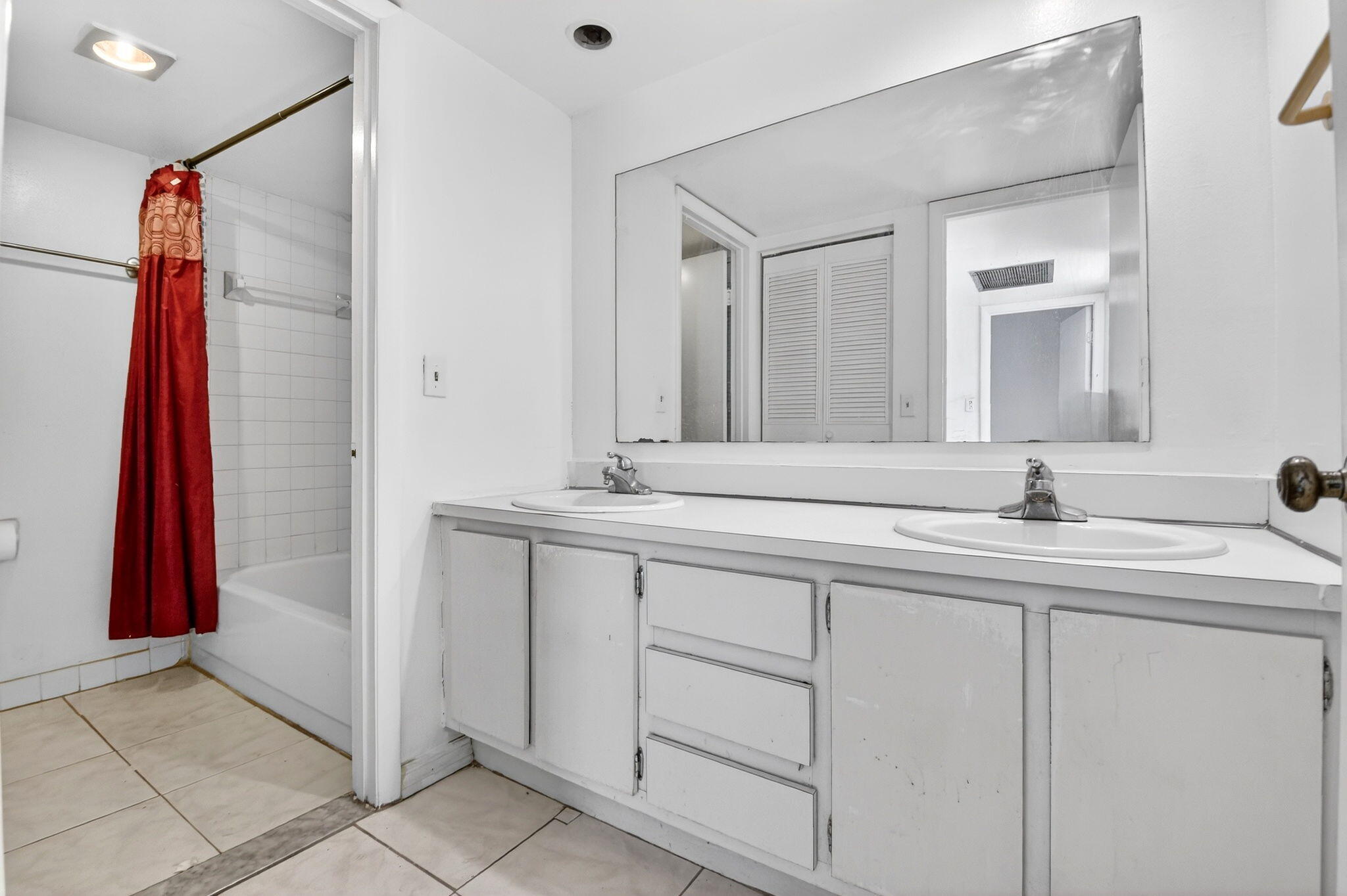 136 Woodland Road Palm Springs, FL 33461 - Photo 37 of 42 a bathroom with a double vanity sink a shower and a mirror