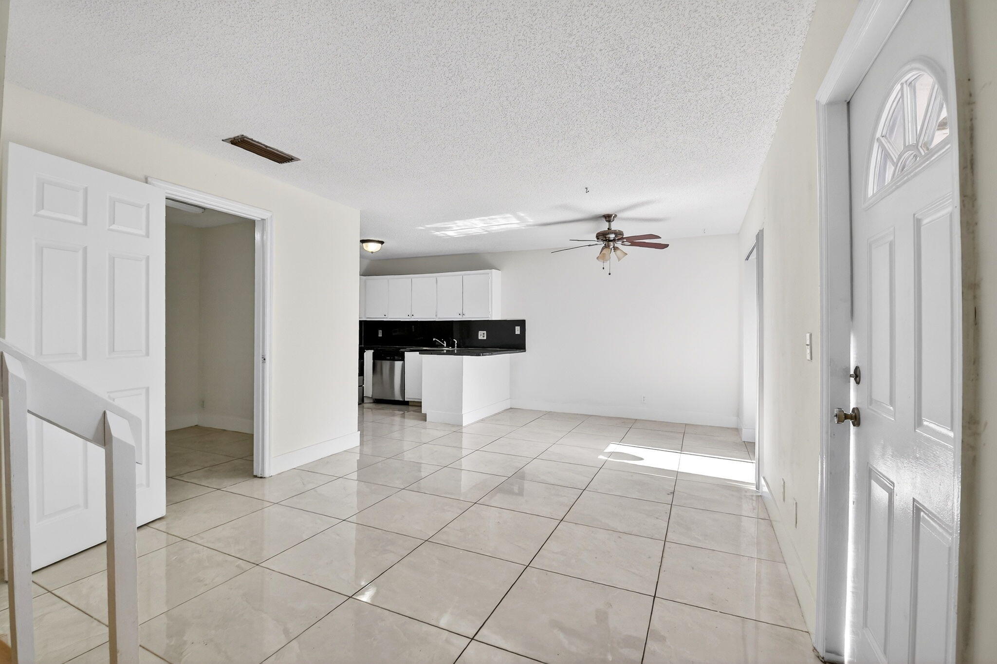 136 Woodland Road Palm Springs, FL 33461 - Photo 6 of 42 a view of a kitchen with a sink and a refrigerator