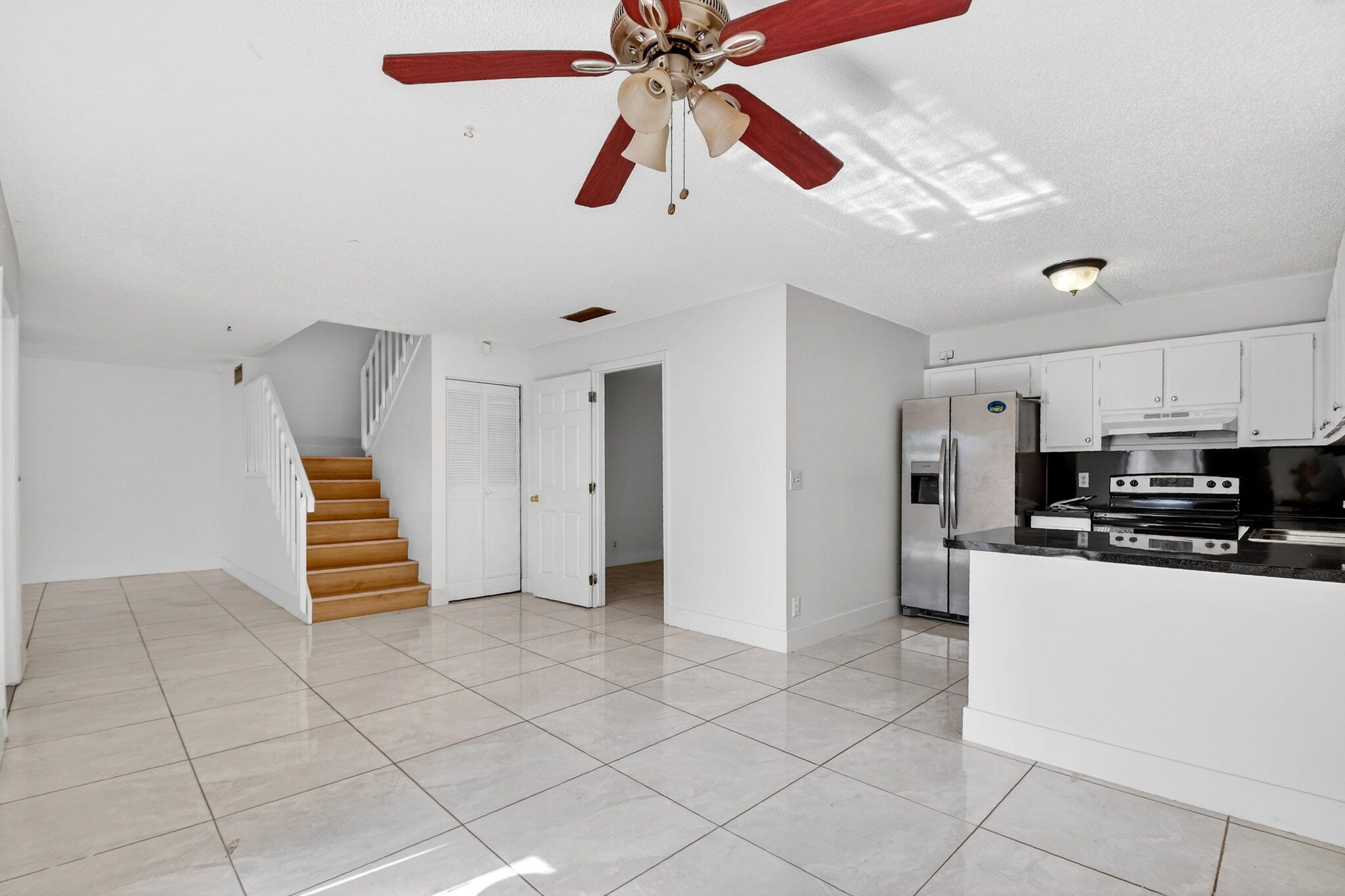 136 Woodland Road Palm Springs, FL 33461 - Photo 8 of 42 a living room with stainless steel appliances furniture and a kitchen view