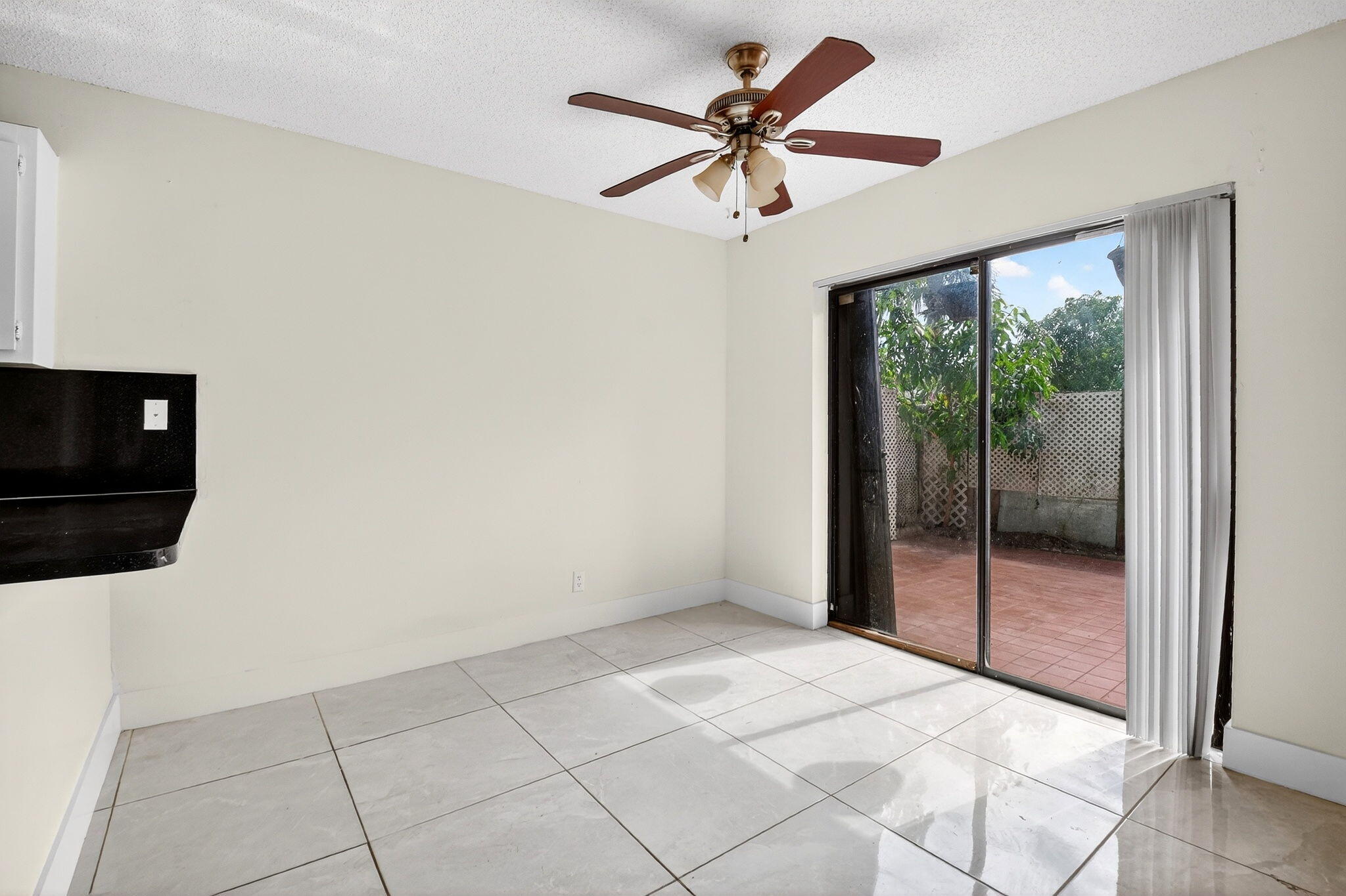 136 Woodland Road Palm Springs, FL 33461 - Photo 9 of 42 a view of a livingroom with a ceiling fan and window