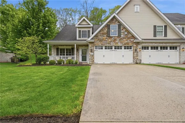 a front view of a house with a garden