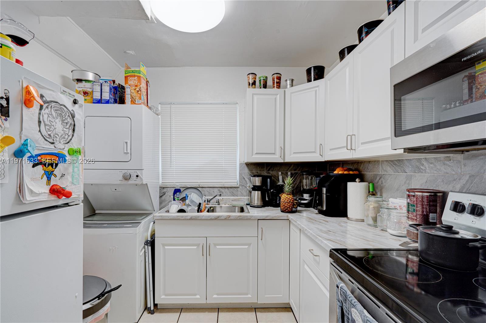 502-504 Phippen Waiters Road, Unit 4 Dania Beach, FL 33004 - Photo 11 of 16 a kitchen with white cabinets and white appliances