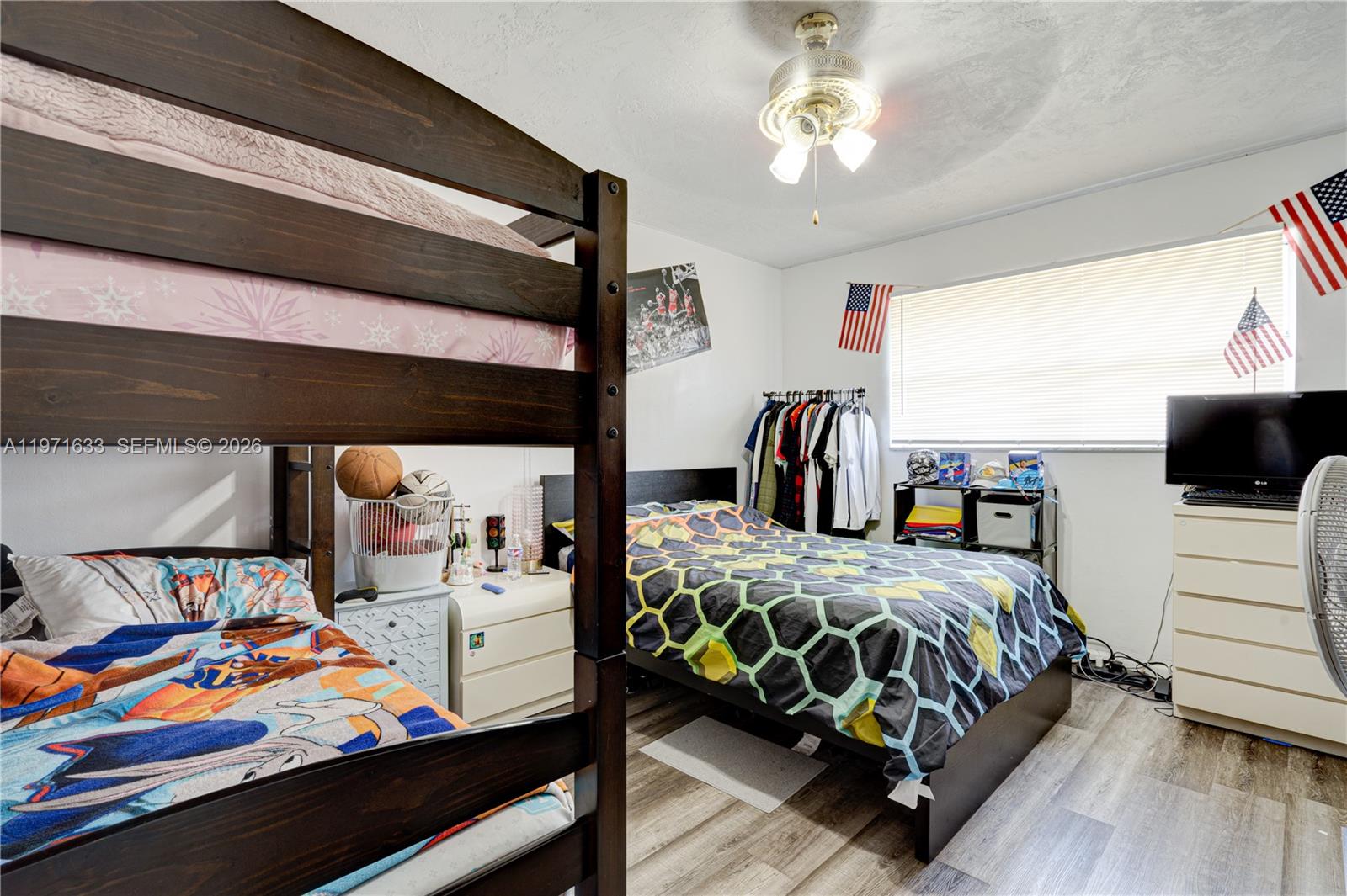 502-504 Phippen Waiters Road, Unit 4 Dania Beach, FL 33004 - Photo 12 of 16 a bedroom with a bed next to a window with the outer view