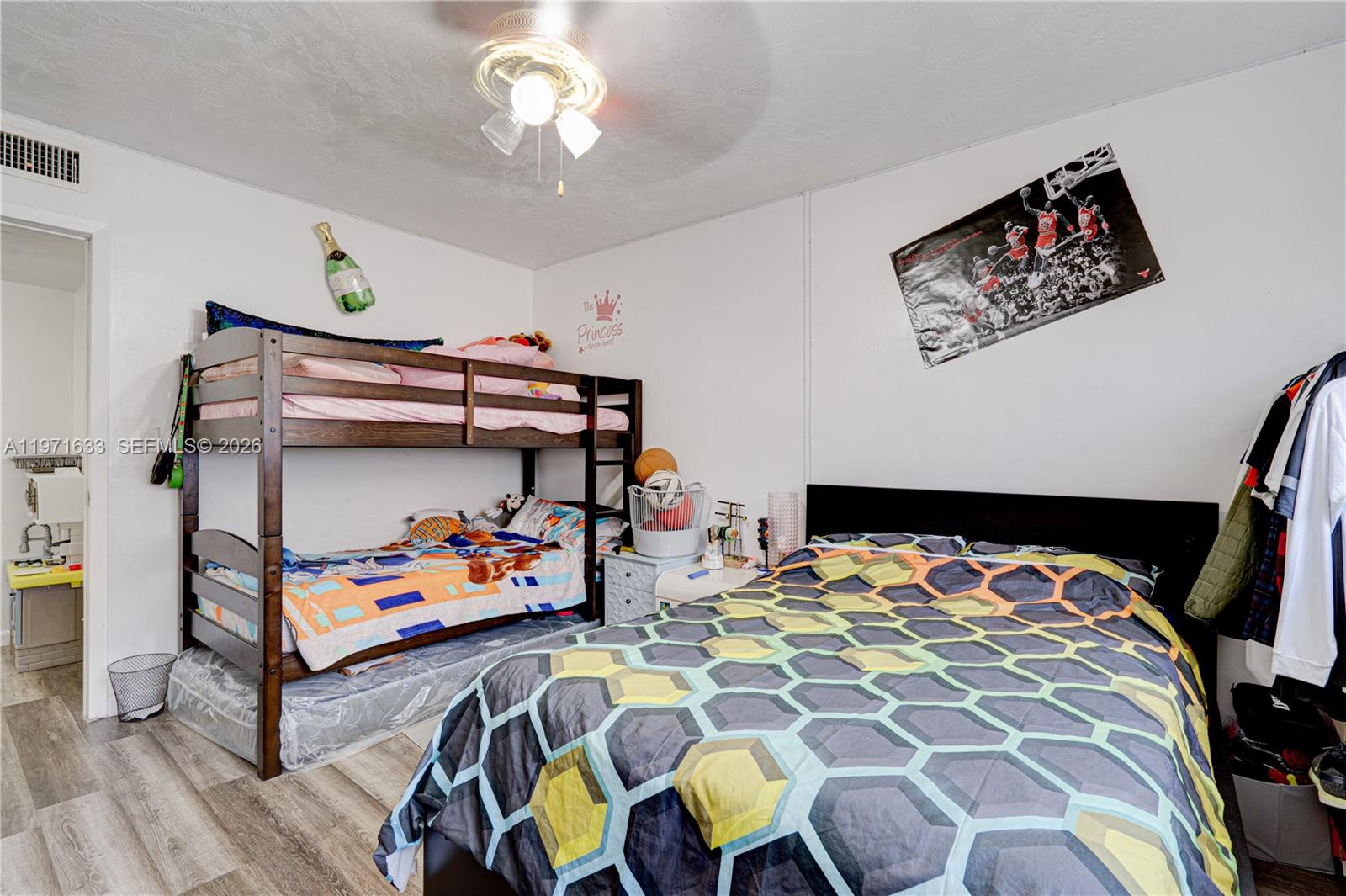 502-504 Phippen Waiters Road, Unit 4 Dania Beach, FL 33004 - Photo 13 of 16 a bedroom with bed and wooden floor