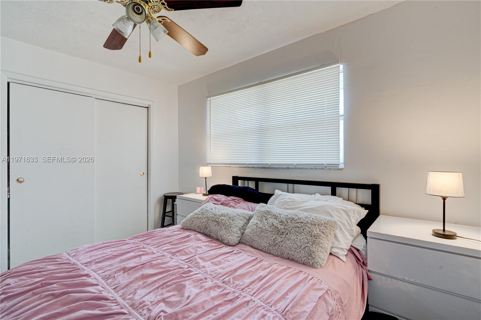 502-504 Phippen Waiters Road, Unit 4 Dania Beach, FL 33004 - Photo 16 of 16 a bedroom with a bed and a chandelier