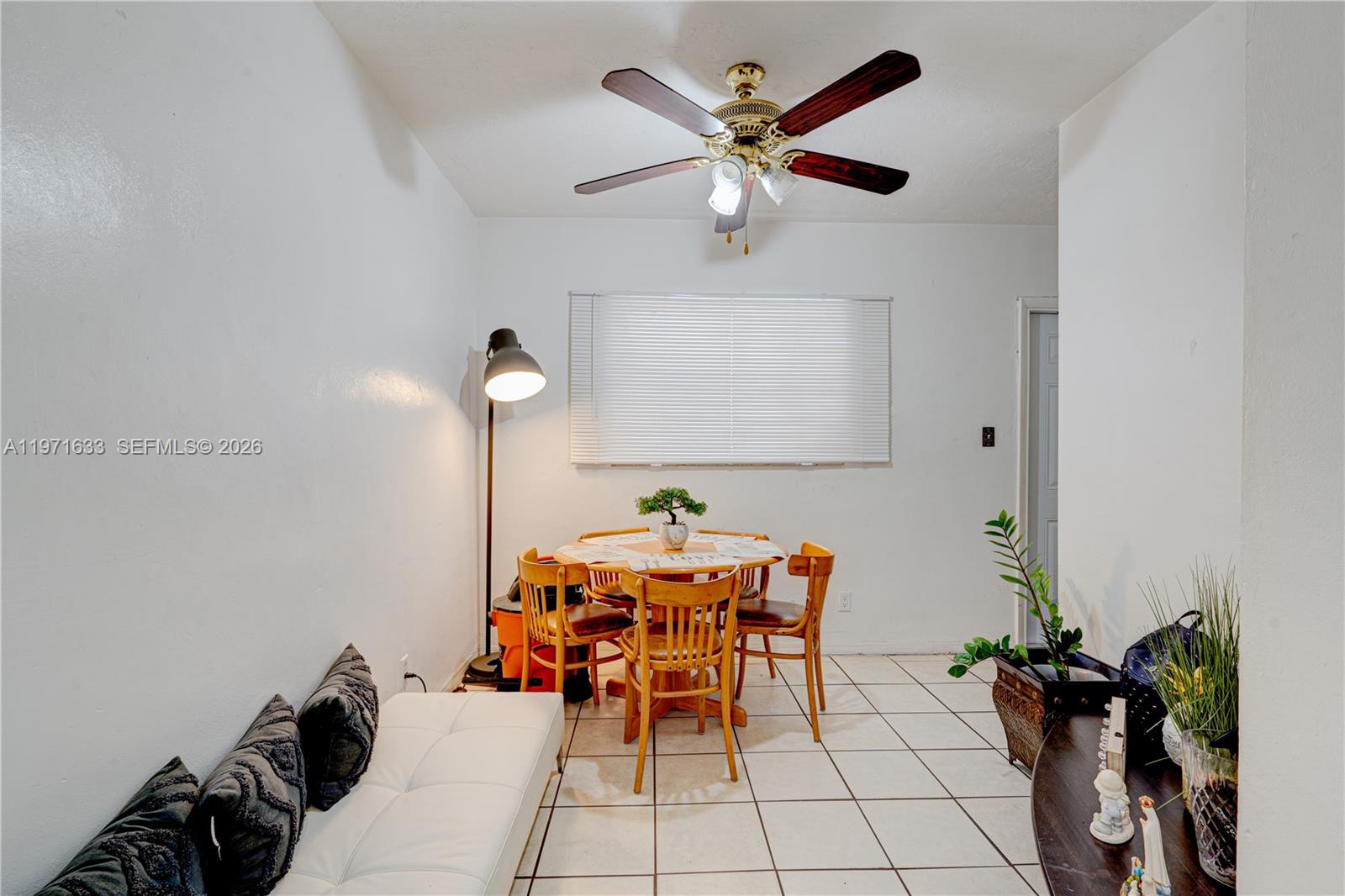 502-504 Phippen Waiters Road, Unit 4 Dania Beach, FL 33004 - Photo 4 of 16 a dining room with furniture and a chandelier