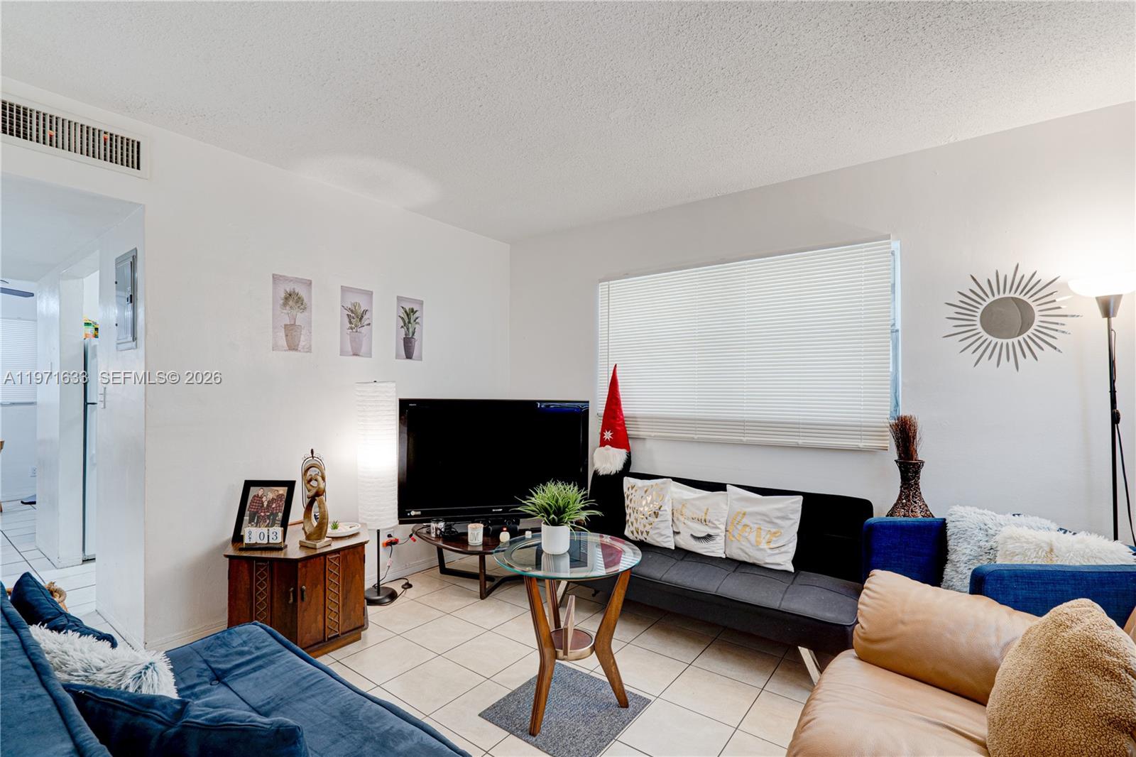 502-504 Phippen Waiters Road, Unit 4 Dania Beach, FL 33004 - Photo 6 of 16 a living room with furniture and a flat screen tv