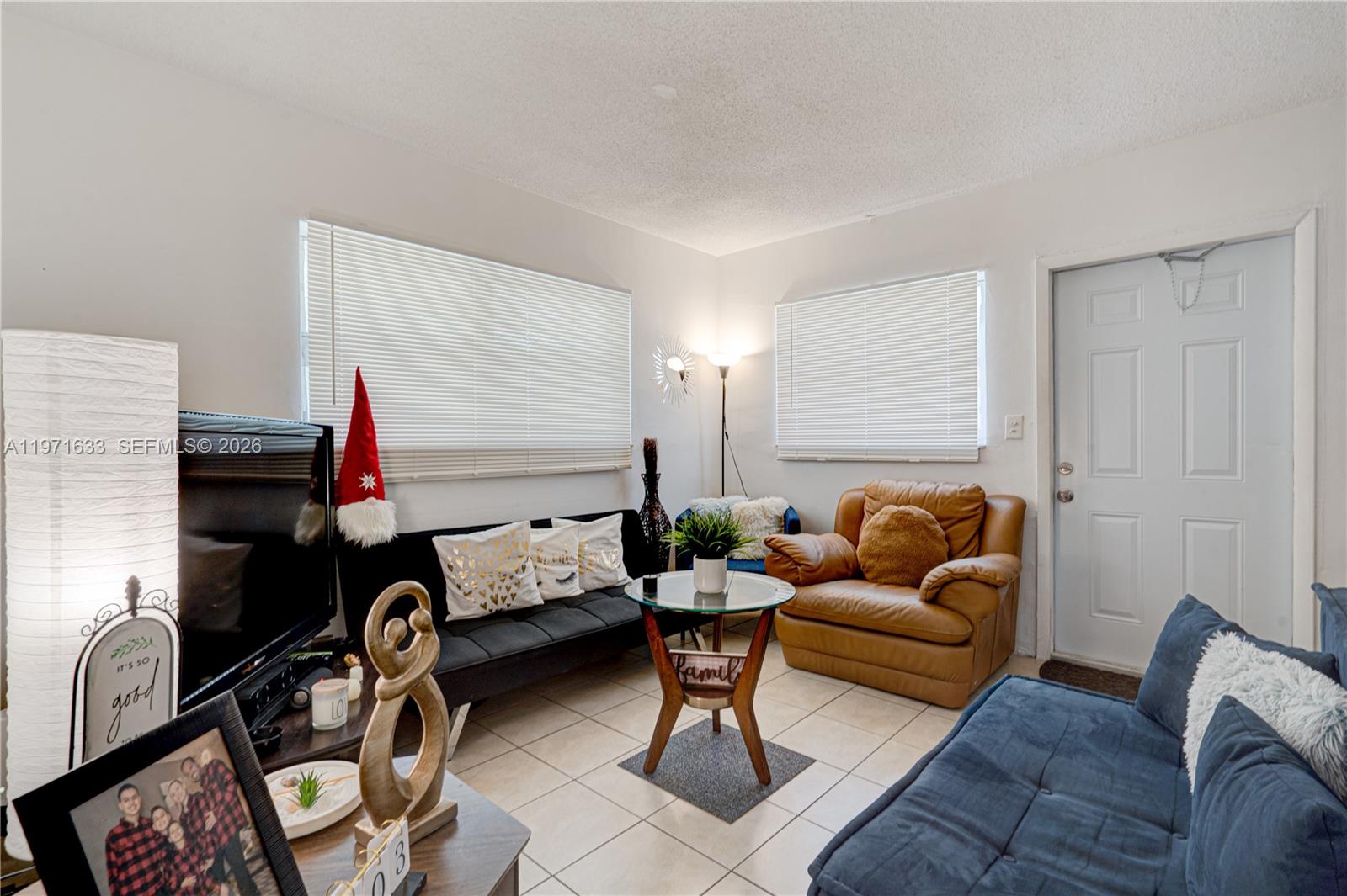 502-504 Phippen Waiters Road, Unit 4 Dania Beach, FL 33004 - Photo 7 of 16 a living room with furniture and a window