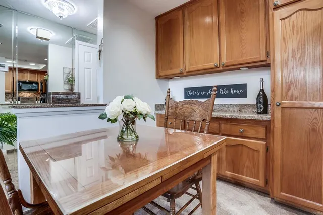 a kitchen with stainless steel appliances granite countertop a sink and a refrigerator