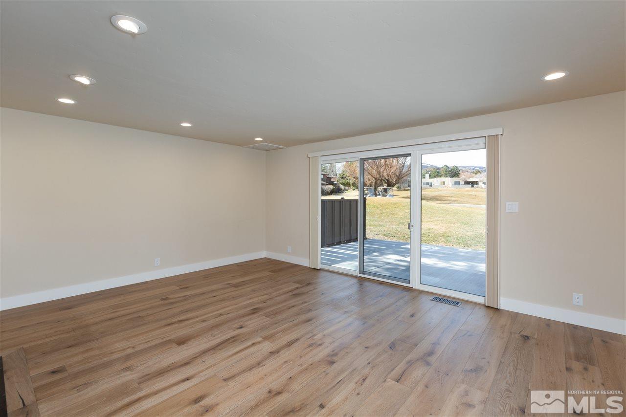 1969 South Villa Way Reno, NV 89509 - Photo 12 of 25 a view of an empty room with wooden floor and a window