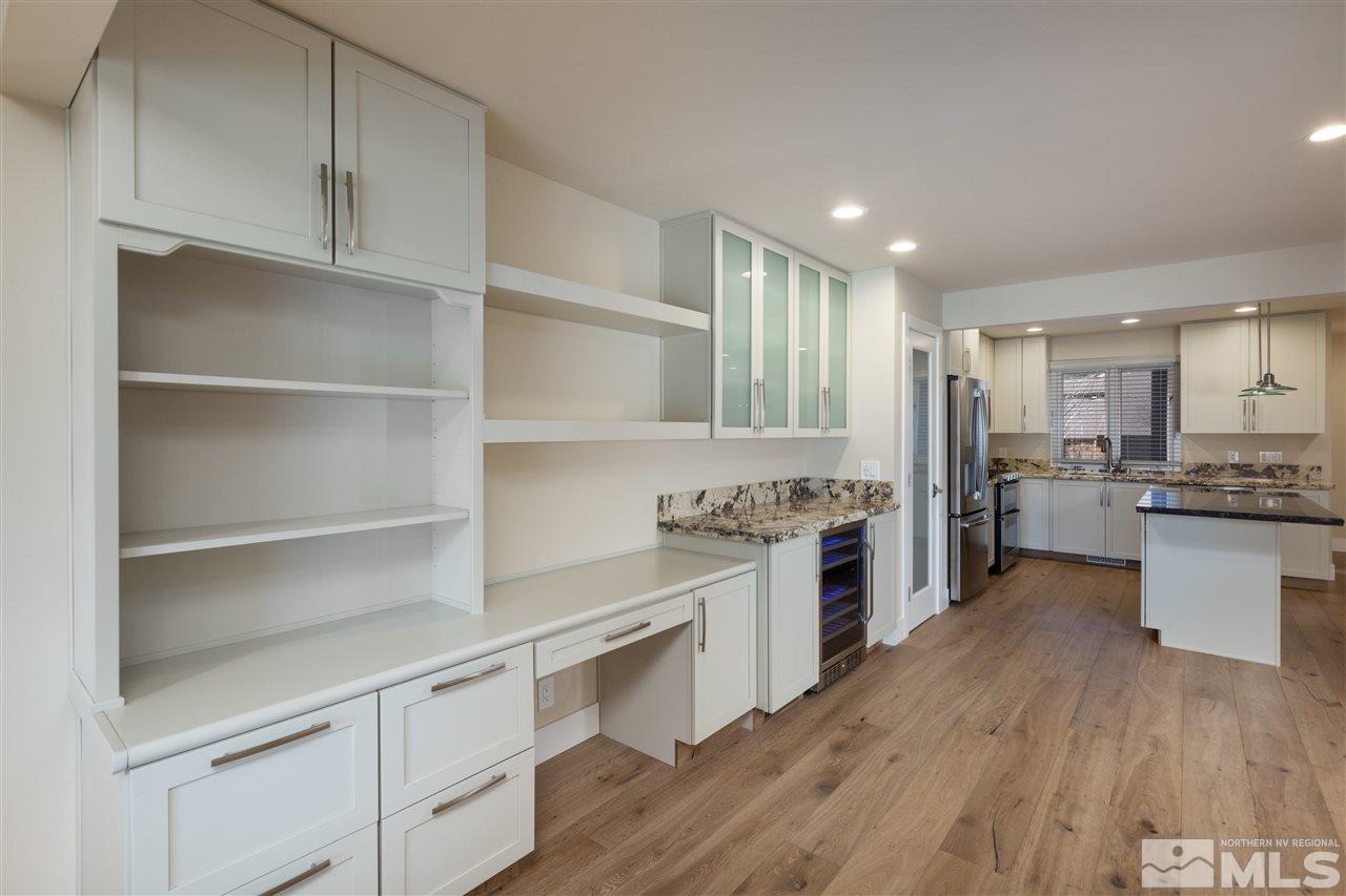 1969 South Villa Way Reno, NV 89509 - Photo 16 of 25 a kitchen with a refrigerator and white cabinets