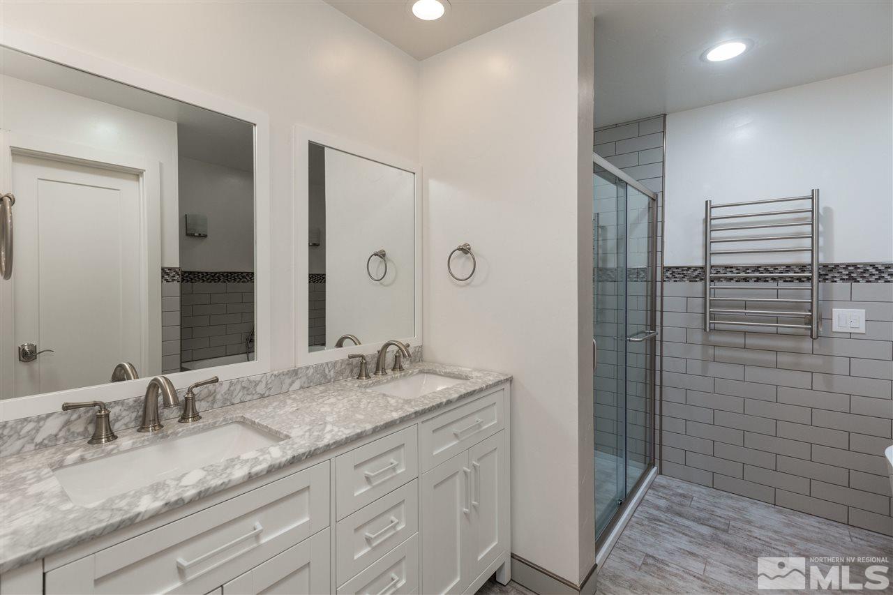 1969 South Villa Way Reno, NV 89509 - Photo 17 of 25 a bathroom with a granite countertop sink and a mirror