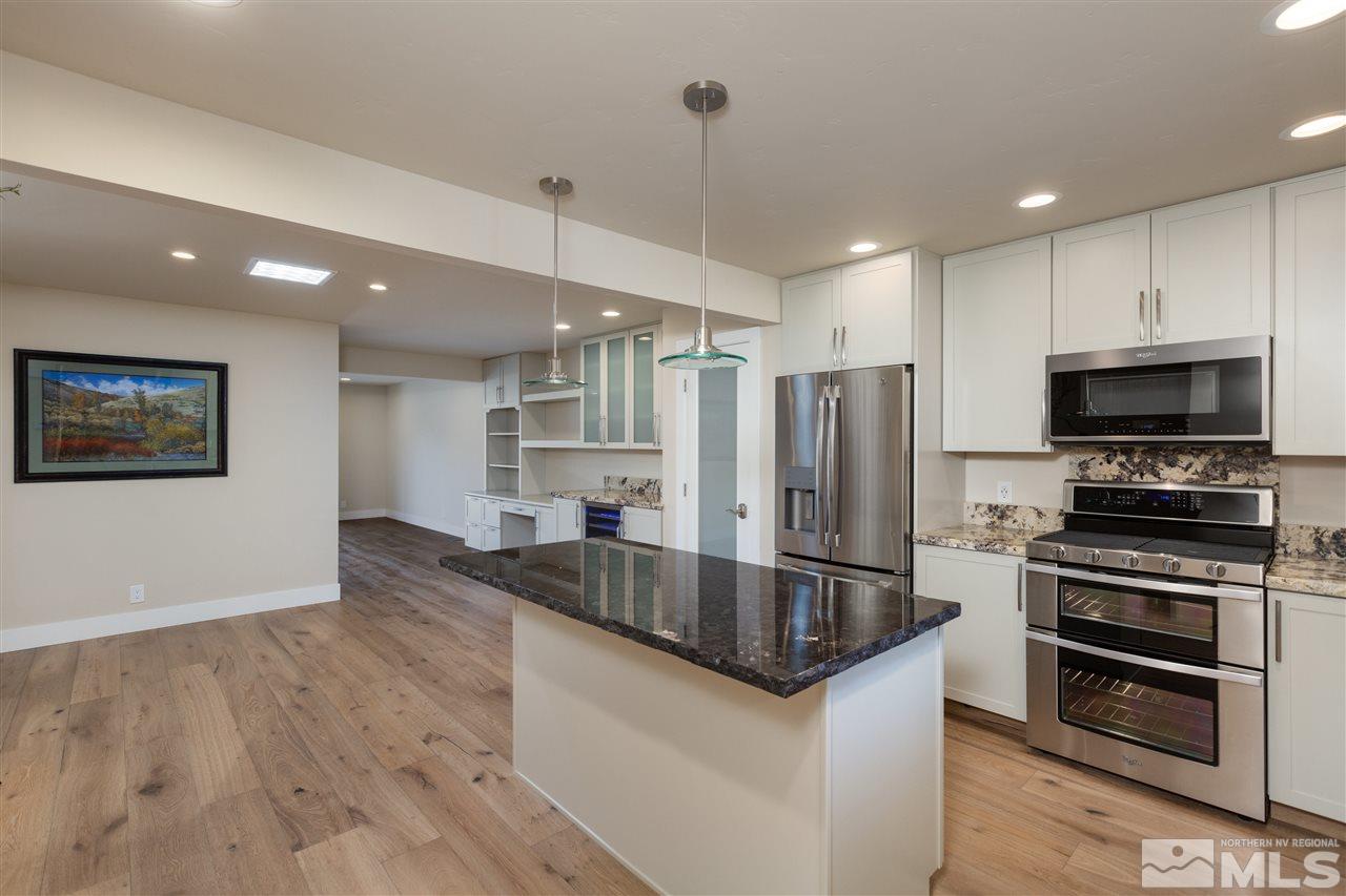 1969 South Villa Way Reno, NV 89509 - Photo 3 of 25 a kitchen with stainless steel appliances granite countertop a refrigerator a stove and a sink