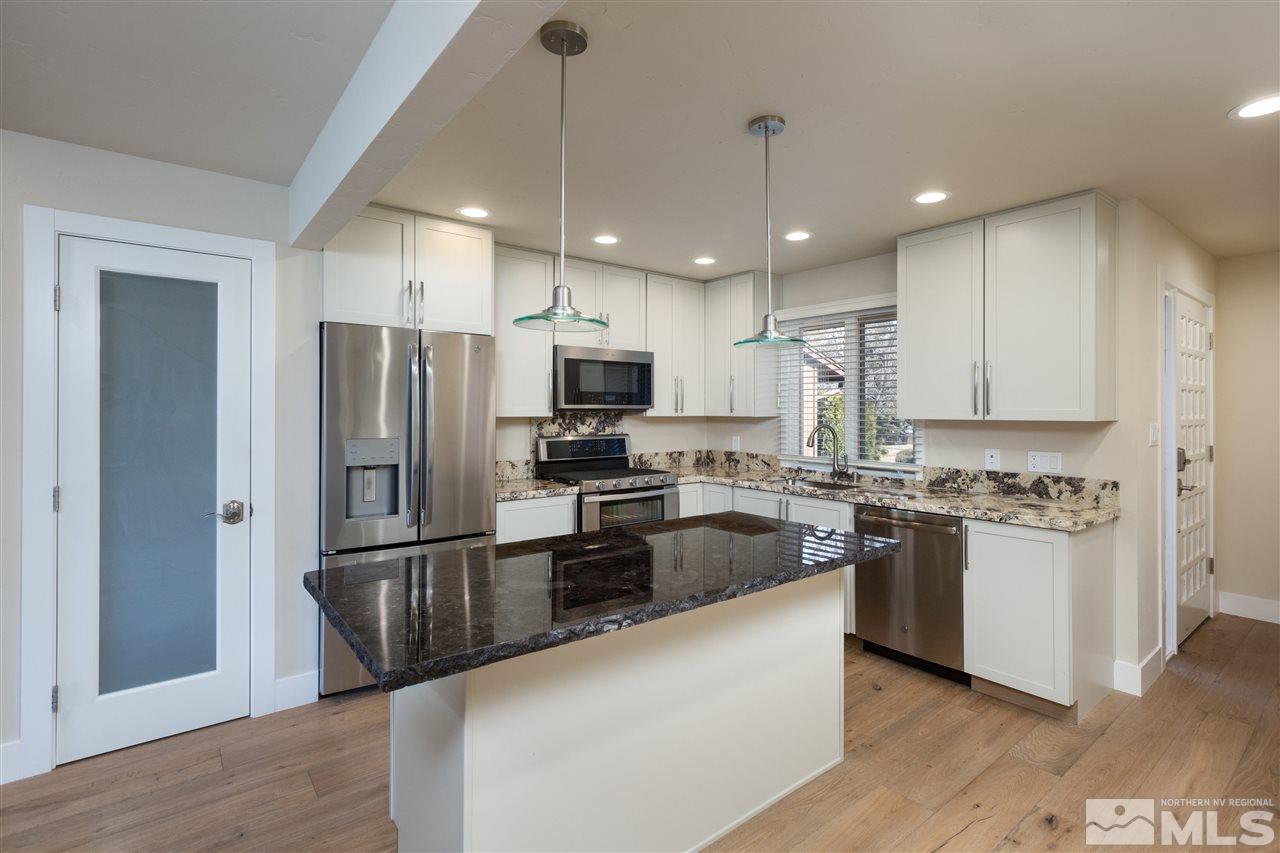 1969 South Villa Way Reno, NV 89509 - Photo 7 of 25 a kitchen with stainless steel appliances granite countertop a refrigerator a stove a sink and a microwave
