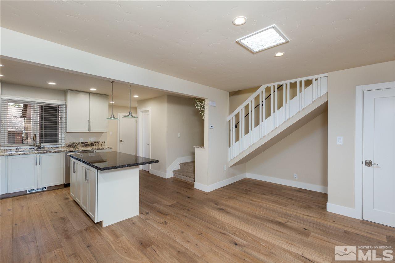 1969 South Villa Way Reno, NV 89509 - Photo 8 of 25 a kitchen with stainless steel appliances a white stove top oven and cabinets