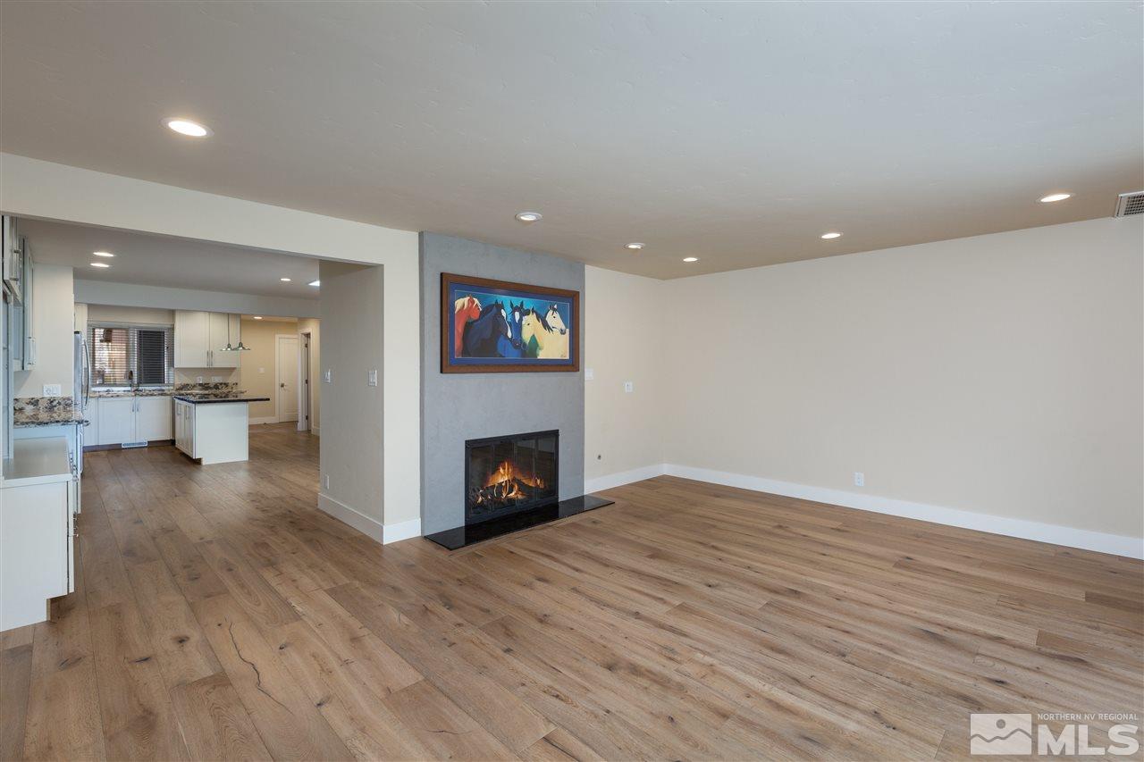 1969 South Villa Way Reno, NV 89509 - Photo 9 of 25 a view of empty room with wooden floor and fireplace