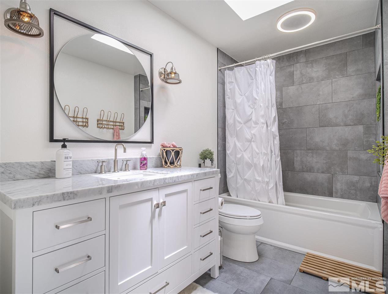 1640 East Valley Road Gardnerville, NV 89410 - Photo 31 of 40 a bathroom with a granite countertop sink toilet and shower