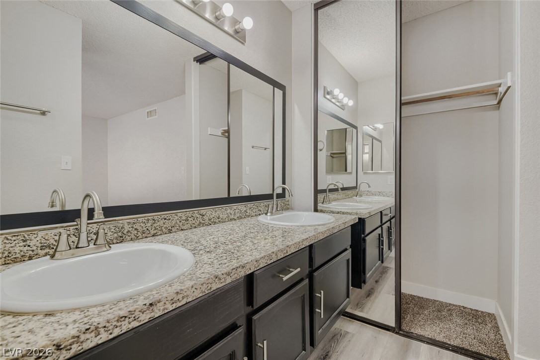 2343 Valleywood Road Henderson, NV 89014 - Photo 23 of 29 Double vanities with sleek granite counters complete this well-appointed bath.