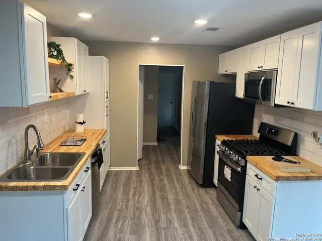 a kitchen with a sink a stove and refrigerator