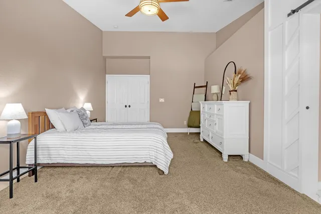 a bedroom with a bed and dresser