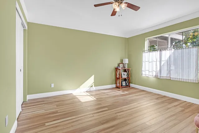 a view of a room with wooden floor and chandelier
