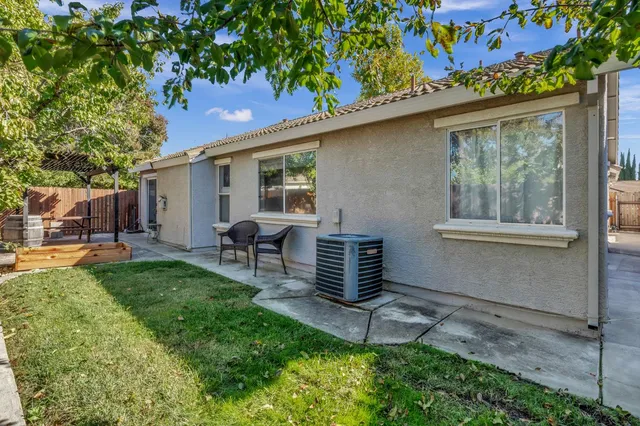 a backyard of a house with table and chairs