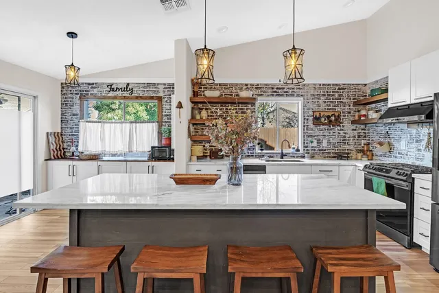 a kitchen with a table chairs stove and cabinets
