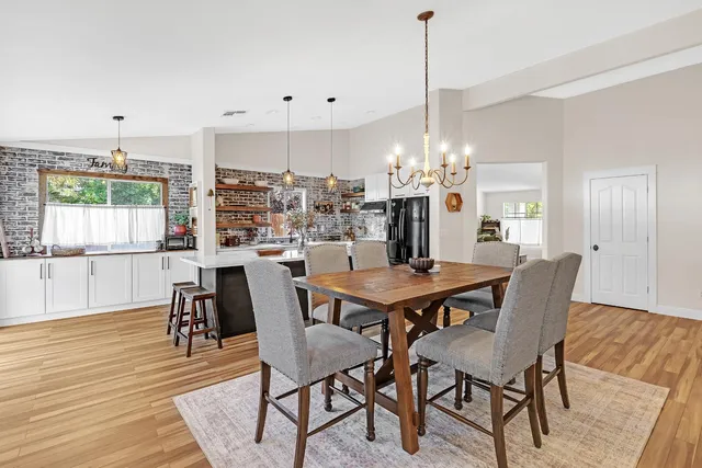 a dining room with furniture window and wooden floor