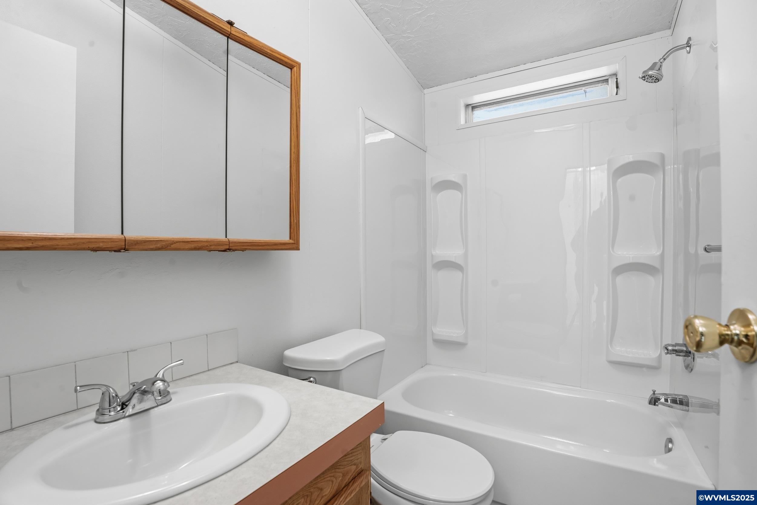 277 Edwards Road, Unit 145 Monmouth, OR 97361 - Photo 22 of 47 a bathroom with a sink toilet and shower