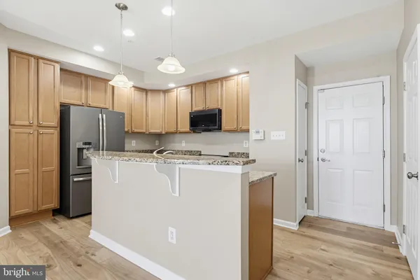 a utility room with refrigerator stove and a window