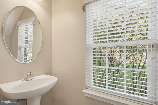 a bathroom with a sink a shower and a mirror