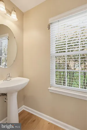 a bathroom with a sink a mirror and a window
