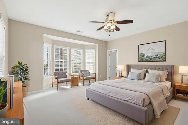 a bedroom with a large bed and a chandelier