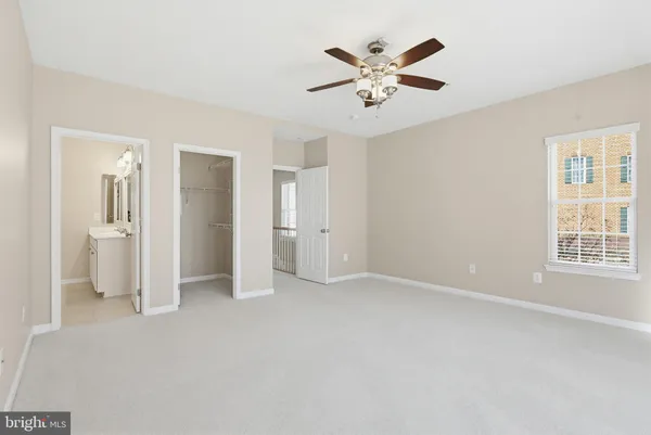 an empty room with a bathroom and a view of bathroom