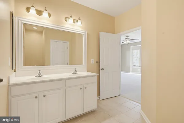 a bathroom with a double vanity sink mirror and