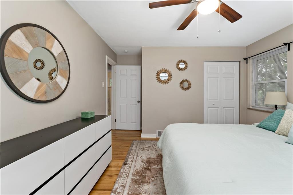 231 Woodside Road Pittsburgh, PA 15221 - Photo 14 of 34 a bedroom with a large bed and a chandelier