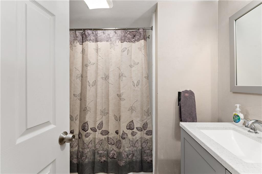 231 Woodside Road Pittsburgh, PA 15221 - Photo 24 of 34 a bathroom with a shower curtain and a sink