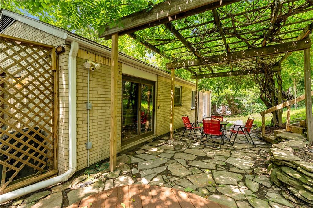 231 Woodside Road Pittsburgh, PA 15221 - Photo 27 of 34 a view of a chairs and table in backyard of the house