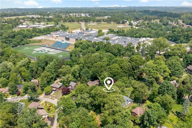 an aerial view of a house with a yard and outdoor seating