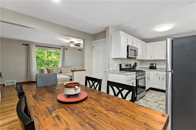 a kitchen with a dining table and chairs