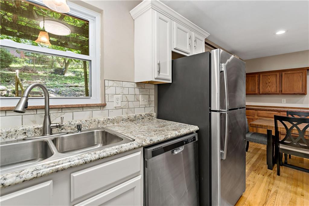 231 Woodside Road Pittsburgh, PA 15221 - Photo 10 of 34 a kitchen with stainless steel appliances granite countertop a refrigerator and a sink