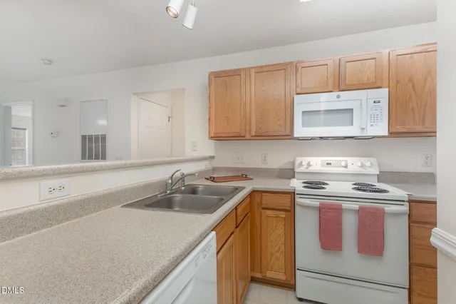 a kitchen with a stove sink and cabinets
